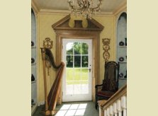 Shutters incorporated into a pine architrave with large hand carved pediment